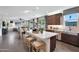 Open kitchen with island seating and stainless steel appliances connecting to living room at 44327 N 43Rd Dr, Phoenix, AZ 85087