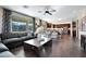 Open-concept living room with large windows connecting to the kitchen and backyard at 44327 N 43Rd Dr, Phoenix, AZ 85087