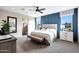 Serene main bedroom featuring wainscotting, natural light, and an ensuite bathroom at 44327 N 43Rd Dr, Phoenix, AZ 85087