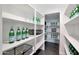 Walk-in pantry with bright white walls and shelving stocked with bottled water and black storage baskets at 44327 N 43Rd Dr, Phoenix, AZ 85087