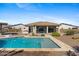 Inviting backyard oasis featuring a sparkling pool, spa and covered patio perfect for outdoor living at 4651 N 204Th Ave, Buckeye, AZ 85396