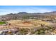 Aerial view of baseball field in community with mountain backdrop under clear skies at 4651 N 204Th Ave, Buckeye, AZ 85396