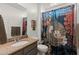 A well lit bathroom with a granite counter top, a shower curtain, and a sink at 4651 N 204Th Ave, Buckeye, AZ 85396