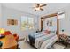 Cozy bedroom with a comfortable murphy bed, natural light, and a ceiling fan at 4651 N 204Th Ave, Buckeye, AZ 85396