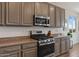 Close up of the kitchen with stainless steel appliances and neutral-toned cabinets at 4651 N 204Th Ave, Buckeye, AZ 85396