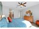 Bright main bedroom featuring a ceiling fan, wood floors, and a stylish dresser at 4651 N 204Th Ave, Buckeye, AZ 85396