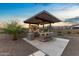 Entertainers dream outdoor kitchen features a bar with seating, built-in grill, and ample counter space at 4651 N 204Th Ave, Buckeye, AZ 85396