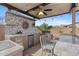 Enjoy outdoor cooking with this outdoor kitchen featuring built-in BBQ and mini fridge at 4651 N 204Th Ave, Buckeye, AZ 85396