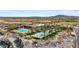 Resort-style community pool with palm trees and lounge chairs against the mountain backdrop at 4651 N 204Th Ave, Buckeye, AZ 85396