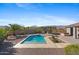 Backyard pool with a hot tub, desert landscaping, a bar, and mountain views at 4651 N 204Th Ave, Buckeye, AZ 85396