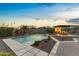 Sparkling pool and outdoor kitchen offers a relaxing and entertaining space with lush landscaping at 4651 N 204Th Ave, Buckeye, AZ 85396