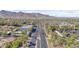 Aerial view of a well-maintained neighborhood with palm tree-lined streets and mountain views at 4651 N 204Th Ave, Buckeye, AZ 85396