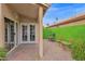 The covered back patio features brick pavers, seating and double doors leading indoors at 473 S Ash St, Gilbert, AZ 85233