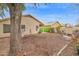 A large backyard featuring a fire pit area, mature trees, and a privacy fence at 473 S Ash St, Gilbert, AZ 85233