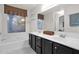 Bathroom with a large soaking tub, dual sinks, and decorative wall shelves at 473 S Ash St, Gilbert, AZ 85233