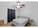 Cozy bedroom featuring laminate flooring, a ceiling fan, and neutral decor at 473 S Ash St, Gilbert, AZ 85233