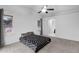 Bright bedroom featuring plush carpet, a ceiling fan, and an ensuite bathroom entrance at 473 S Ash St, Gilbert, AZ 85233