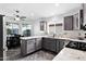 Bright kitchen with granite countertops, stainless steel appliances, a breakfast bar, and tile flooring at 473 S Ash St, Gilbert, AZ 85233