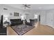 Open living room featuring hardwood floors, neutral walls, ceiling fan, and comfortable gray sofas with an accent rug at 473 S Ash St, Gilbert, AZ 85233