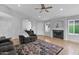 Cozy living room with a fireplace, ceiling fan, hardwood floors, and comfortable seating in a neutral color palette at 473 S Ash St, Gilbert, AZ 85233