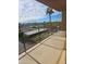 Spacious balcony showcasing city views, palm trees, and distant mountains under a sunny, cloud-filled sky at 4750 N Central Ave # D4, Phoenix, AZ 85012