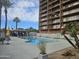 Resort-style swimming pool with a gazebo and lounge chairs surrounded by palm trees under a sunny, blue sky at 4750 N Central Ave # D4, Phoenix, AZ 85012