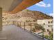 Expansive outdoor balcony featuring desert views with modern railing and a wood plank ceiling at 5000 N Camelback Ridge Dr # 409, Scottsdale, AZ 85251