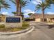 Inviting community entrance featuring stone signage and mature palm trees at 5000 N Camelback Ridge Dr # 409, Scottsdale, AZ 85251