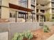 Apartment complex entrance featuring modern design, xeriscaping, and desert plants at 5000 N Camelback Ridge Dr # 409, Scottsdale, AZ 85251