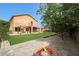 A large backyard with well manicured grass, a small balcony, and a brick firepit at 509 W Princeton Ave, Gilbert, AZ 85233