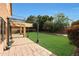 The backyard features green grass, a pergola, and a brick patio at 509 W Princeton Ave, Gilbert, AZ 85233