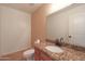 Powder room featuring granite countertop, tile floor, and white fixtures at 509 W Princeton Ave, Gilbert, AZ 85233