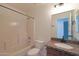 Bathroom showcases tub, tile surround, granite counter and storage cabinets at 509 W Princeton Ave, Gilbert, AZ 85233