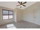 This bedroom includes a ceiling fan, closet space, and a large window at 509 W Princeton Ave, Gilbert, AZ 85233