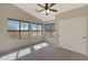 Bright bedroom featuring three windows, ceiling fan, and closet space at 509 W Princeton Ave, Gilbert, AZ 85233