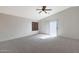 Spacious bedroom with neutral carpet, ceiling fan, and sliding glass doors at 509 W Princeton Ave, Gilbert, AZ 85233