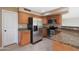 Kitchen featuring stainless appliances, wood cabinets, and granite countertops at 509 W Princeton Ave, Gilbert, AZ 85233