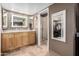 Modern bathroom with double vanity, framed mirrors, and walk-in shower at 5318 W Aire Libre Ave, Glendale, AZ 85306