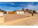 Single-story brick home with a three-car garage and low maintenance desert landscaping at 5318 W Aire Libre Ave, Glendale, AZ 85306