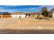 Charming single-story brick home featuring a three-car garage and low maintenance desert landscaping at 5318 W Aire Libre Ave, Glendale, AZ 85306