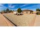 Single-story brick home featuring a three-car garage and low maintenance desert landscaping at 5318 W Aire Libre Ave, Glendale, AZ 85306