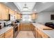 Bright kitchen features light wood cabinets, tile floors, a large window, and stainless steel appliances at 5318 W Aire Libre Ave, Glendale, AZ 85306