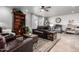 Comfortable living room with a bookcase, ceiling fan, and decorative rugs at 5318 W Aire Libre Ave, Glendale, AZ 85306