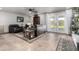 Relaxing living room with cozy seating, a ceiling fan, and french doors leading to the backyard at 5318 W Aire Libre Ave, Glendale, AZ 85306