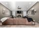 Spacious living room featuring a large leather sectional, stone fireplace, and recessed lighting at 5318 W Aire Libre Ave, Glendale, AZ 85306