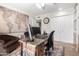 Well-lit home office featuring a desk, comfortable chair, and decorative world map at 5318 W Aire Libre Ave, Glendale, AZ 85306