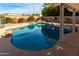 Inviting in-ground pool with cool blue water, rock accents and lush landscaping for backyard oasis at 5318 W Aire Libre Ave, Glendale, AZ 85306