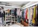 Walk-in closet featuring customized shelving, ample storage space and organized clothing at 5318 W Aire Libre Ave, Glendale, AZ 85306