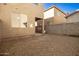 Backyard view with gravel landscaping, block walls, and ample space for customization at 5430 W Odeum Ln, Phoenix, AZ 85043