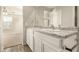 Bright bathroom with a double sink vanity and a view into the bedroom at 5430 W Odeum Ln, Phoenix, AZ 85043